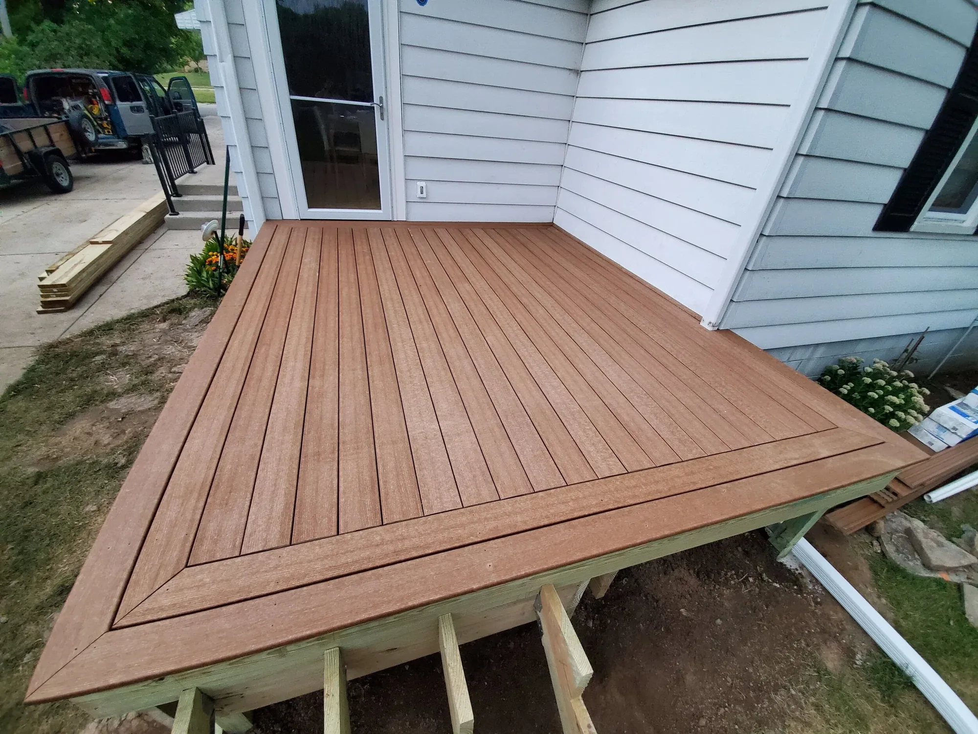 New wood deck built off the back of a house