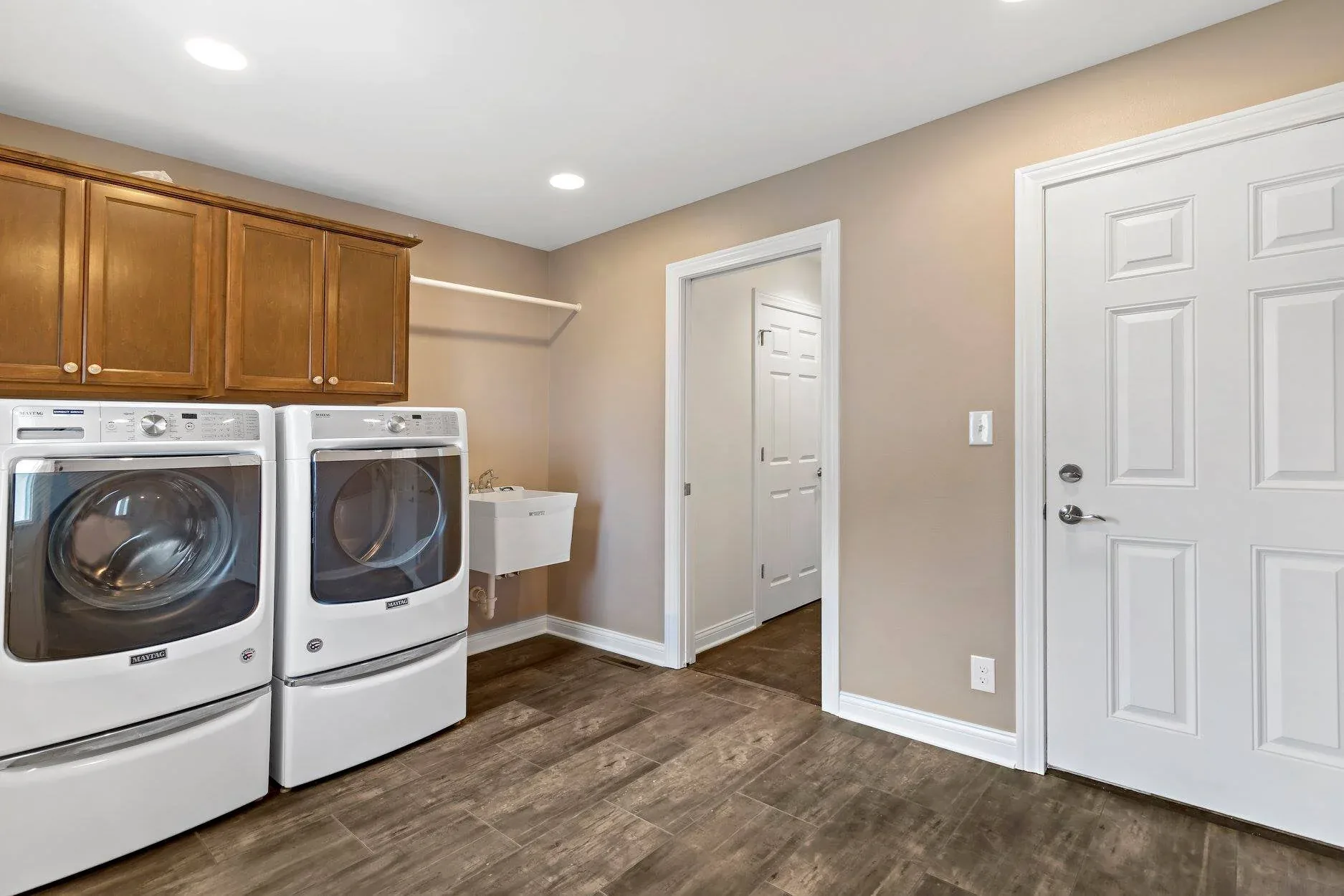 Remodeled laundry room with a washer, dryer and new flooring